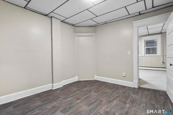 a view of a room with wooden floor and a window