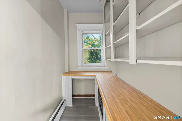 a view of an entryway with wooden floor and staircase