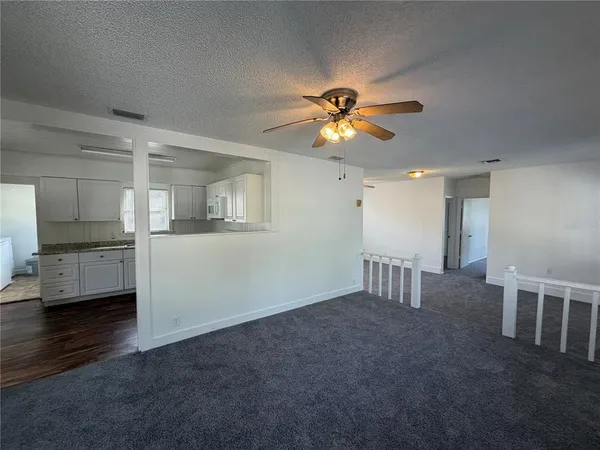 a view of a livingroom with a kitchen
