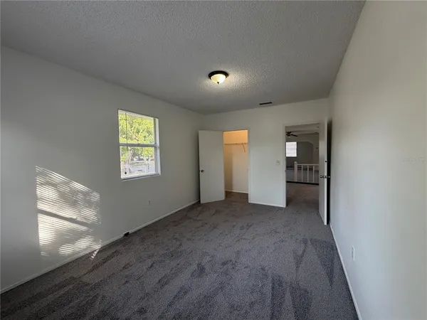 an empty room with windows and entrance