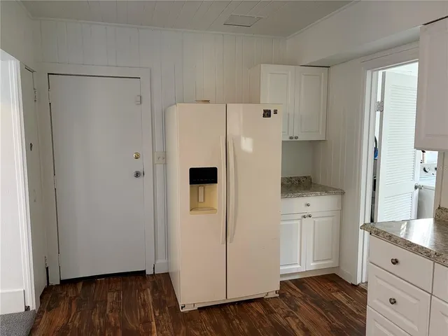 a white refrigerator freezer sitting inside of a kitchen