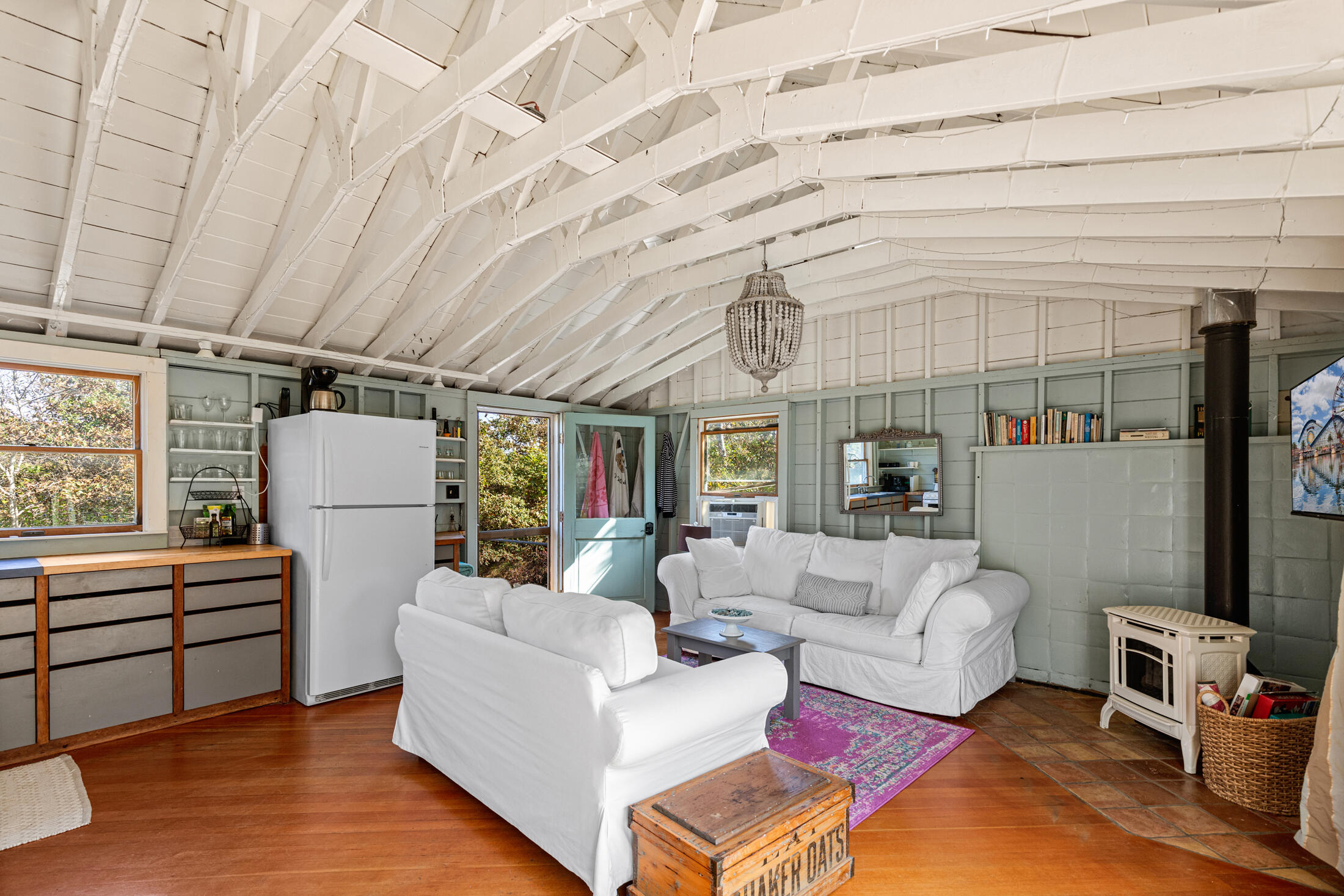 135 Nauset Light Beach Road Eastham, MA 02642 - Photo 13 of 34 a living room with furniture and a chandelier