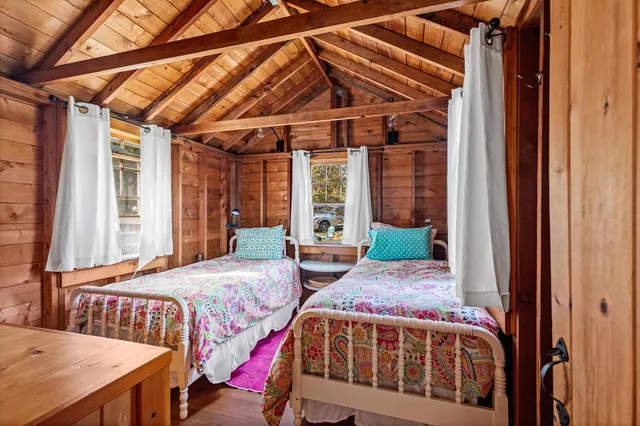 a bedroom with two beds and a window