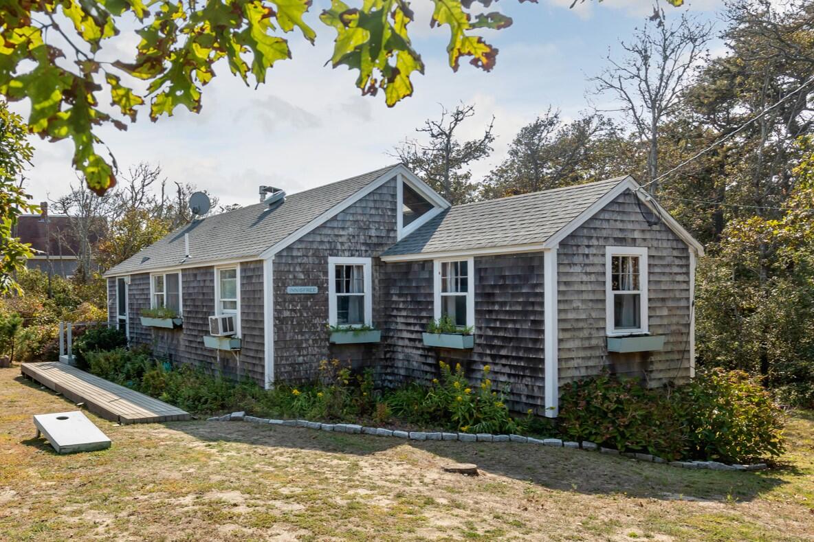 135 Nauset Light Beach Road Eastham, MA 02642 - Photo 2 of 34 a front view of a house with garden