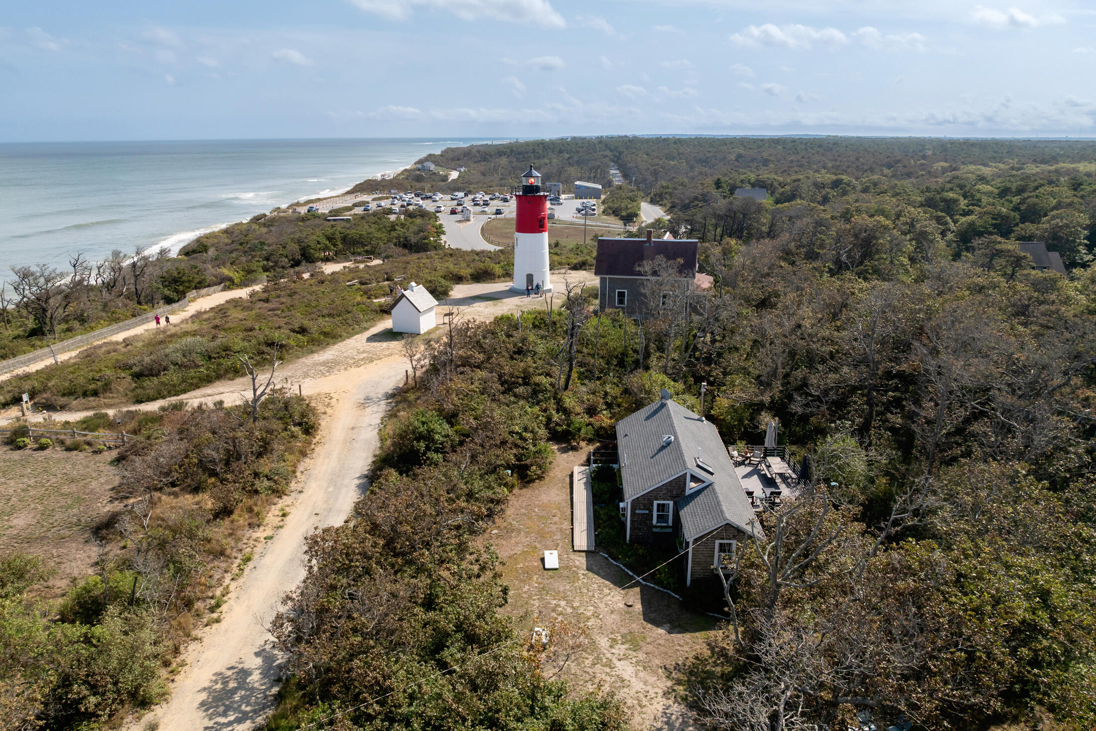 135 Nauset Light Beach Road Eastham, MA 02642 - Photo 24 of 34 an aerial view of a house with a yard and mountain view in back