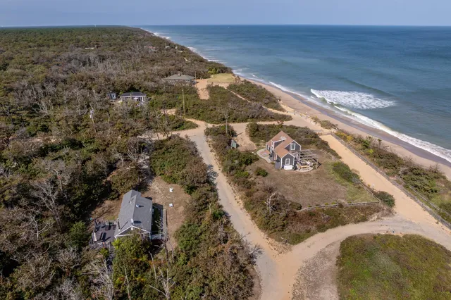 an aerial view of a house with yard and outdoor seating