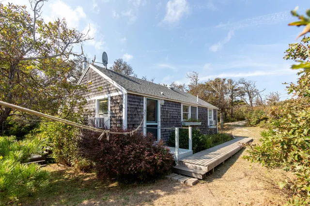 a view of a house with a yard and sitting area