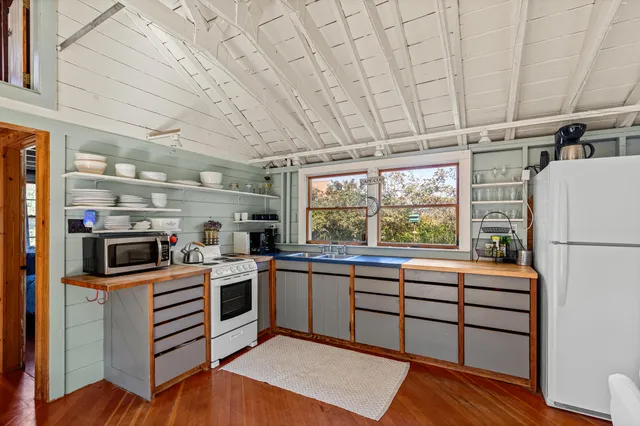 a kitchen with a sink appliances and cabinets