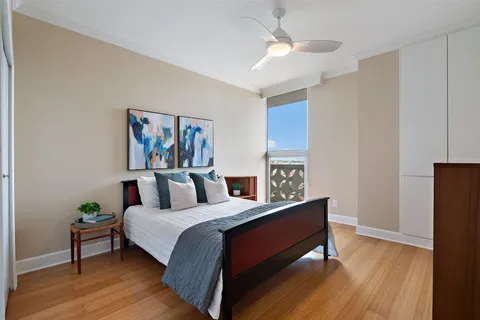 a bedroom with a bed and a painting on the wall