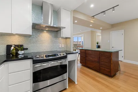 a kitchen with wooden cabinets and a stove top oven