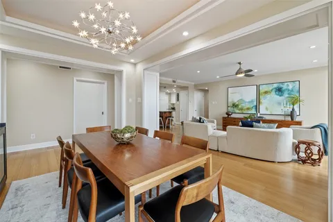 a view of a dining room with furniture and chandelier