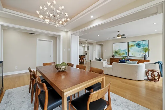 a view of a dining room with furniture and chandelier
