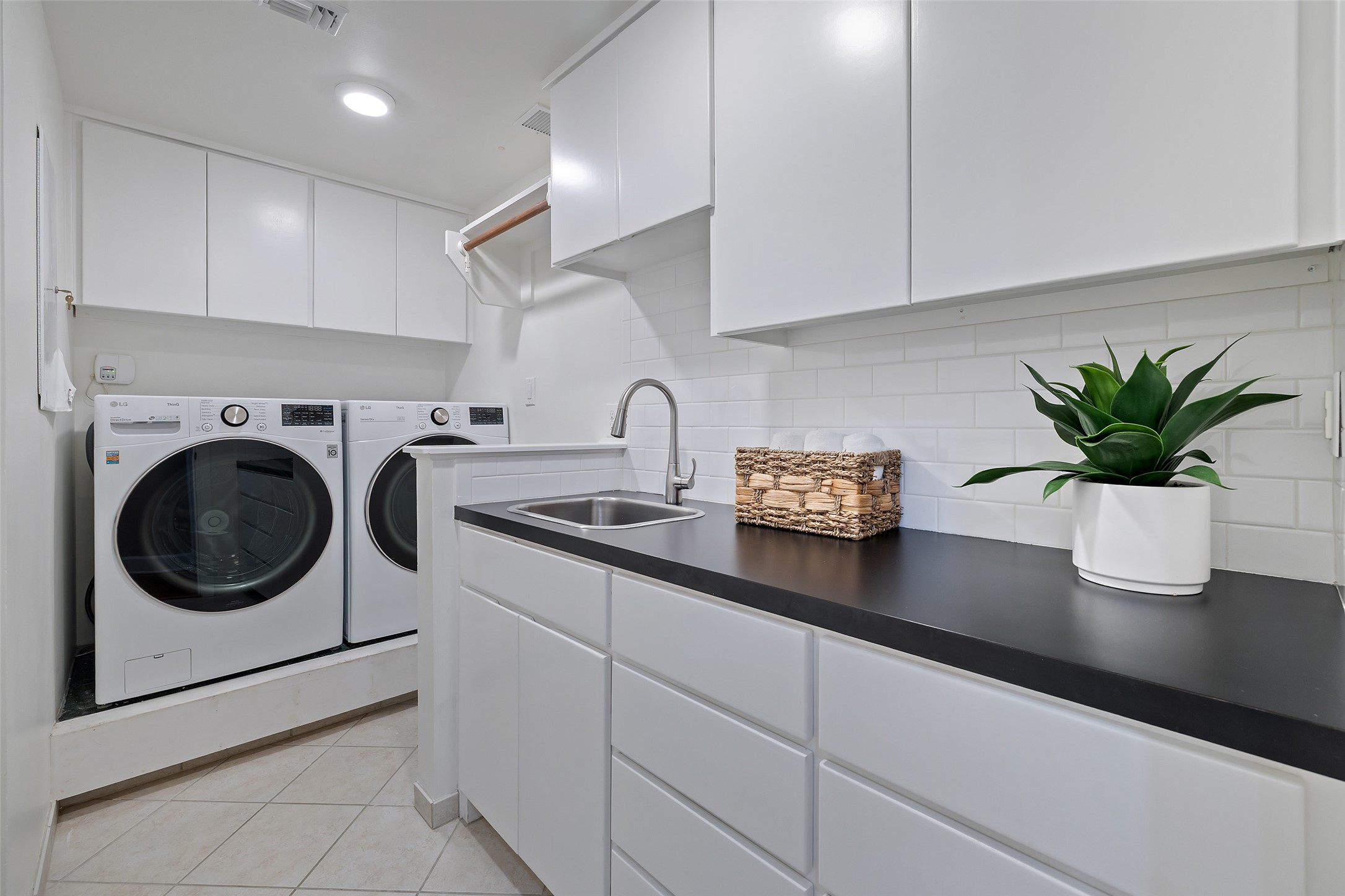 1801 Lavaca Street, Unit 13EF Austin, TX 78701 - Photo 26 of 40 Laundry room with separate washer and dryer, cabinet space, light tile patterned floors, and recessed lighting