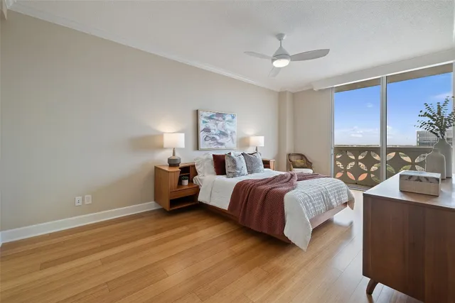 a spacious bedroom with a bed and a dresser