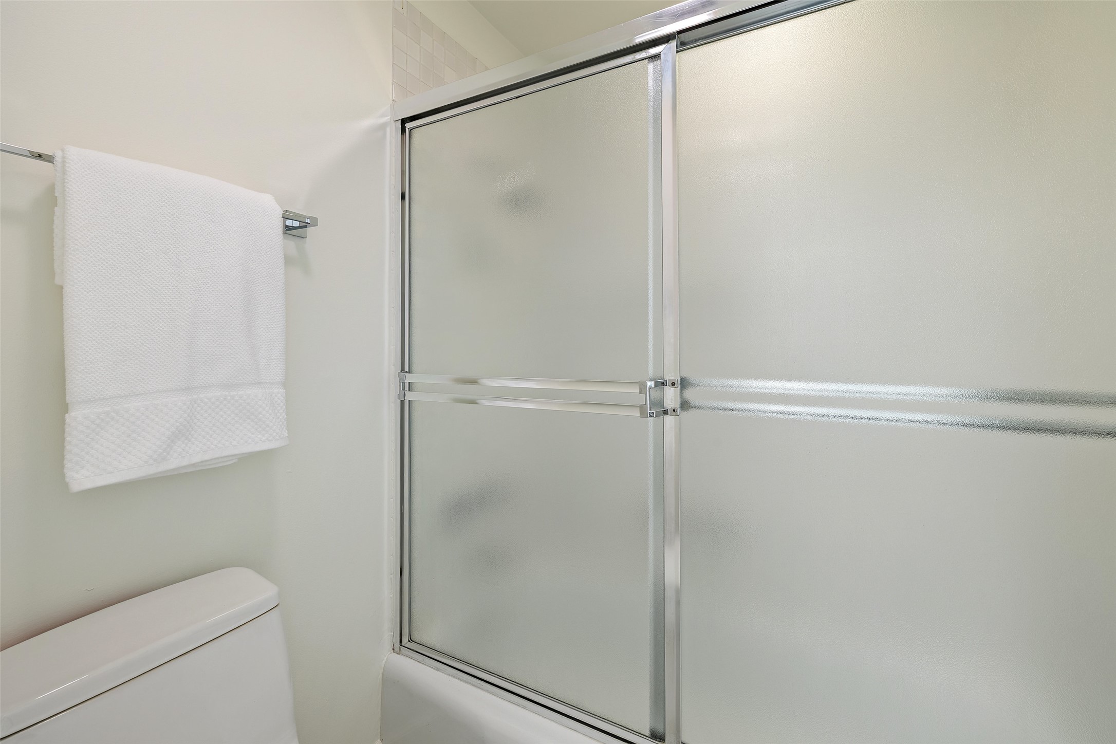 1801 Lavaca Street, Unit 13EF Austin, TX 78701 - Photo 32 of 40 Bathroom with toilet and combined bath / shower with glass door