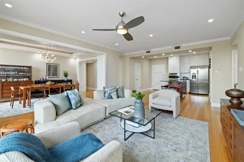 a living room with furniture and a view of kitchen