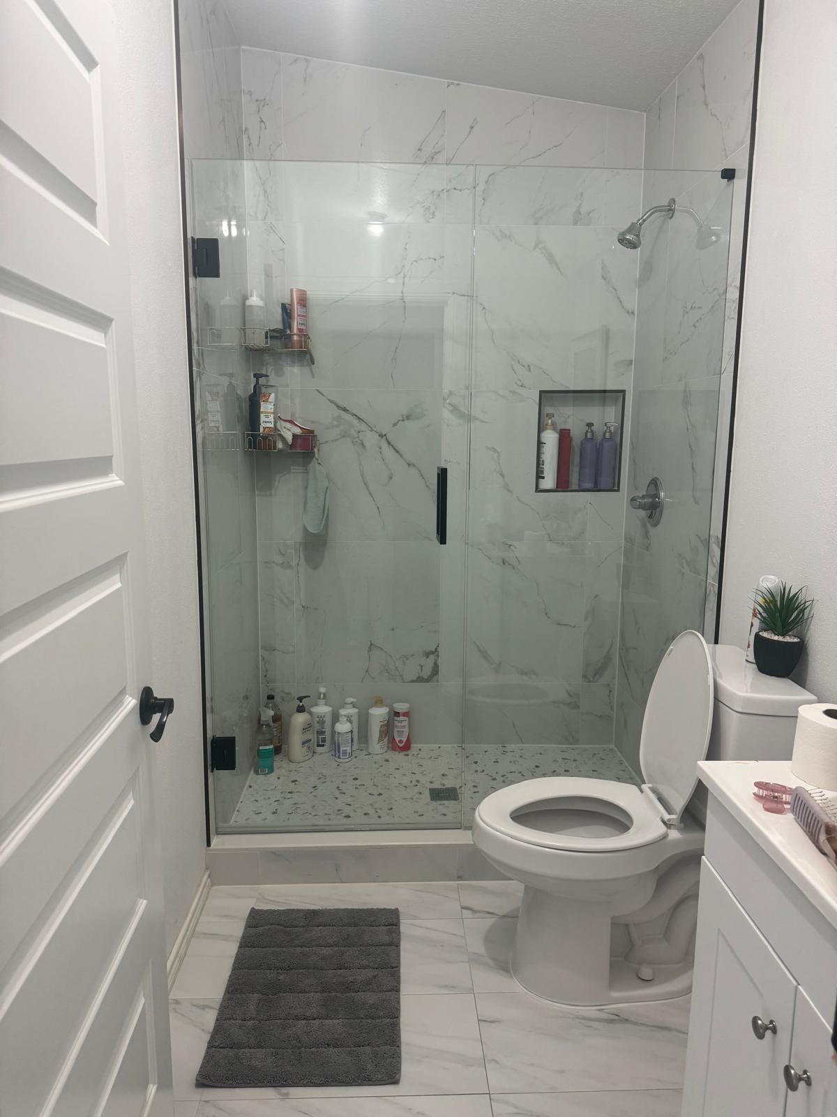 401 Ride Out Boulevard Elgin, TX 78621 - Photo 10 of 11 a bathroom with a toilet and a shower
