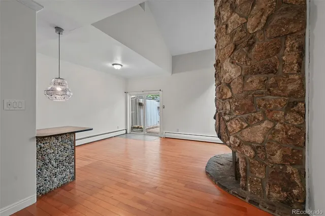 a view of empty room with wooden floor