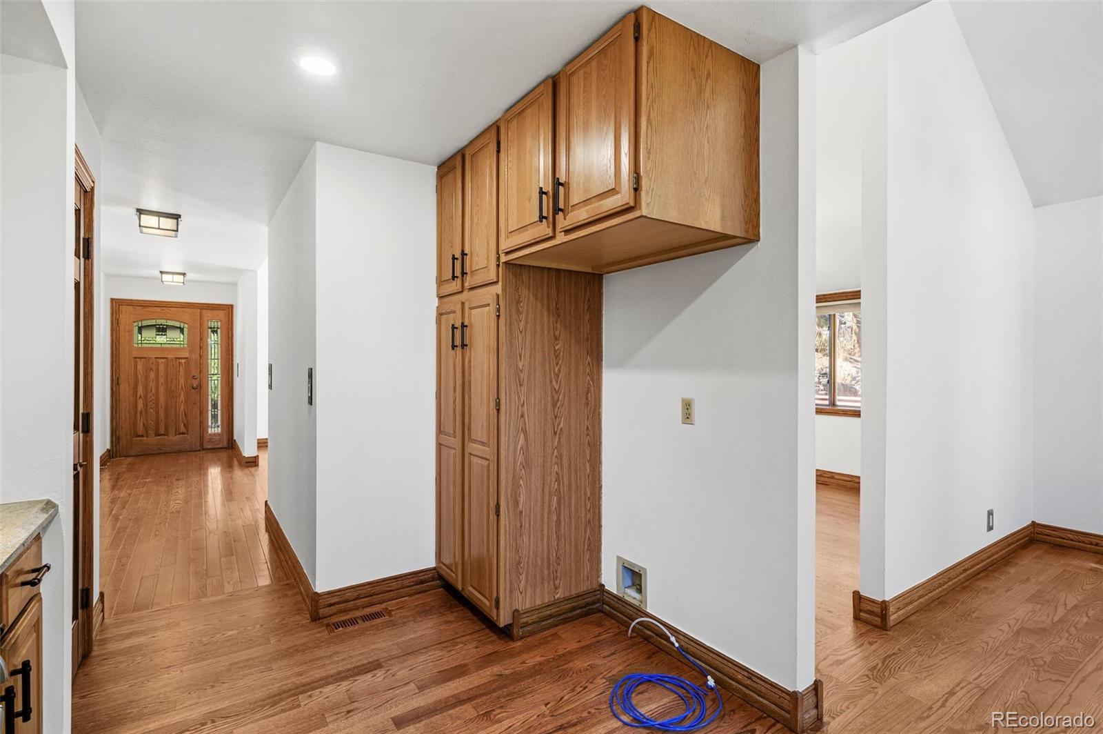 30243 Pine Crest Drive Evergreen, CO 80439 - Photo 15 of 36 a view of a hallway with wooden floor and entryway with wooden floor