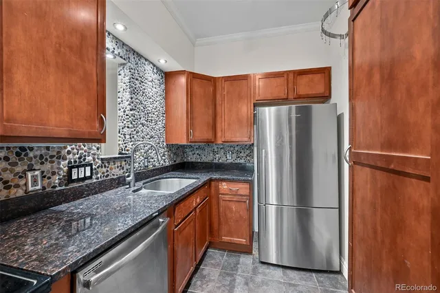 a kitchen with granite countertop stainless steel appliances a sink stove top oven and microwave