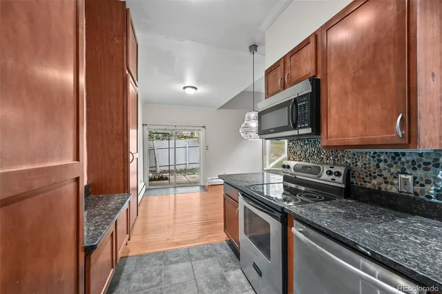 a bathroom with a granite countertop sink a toilet and a mirror