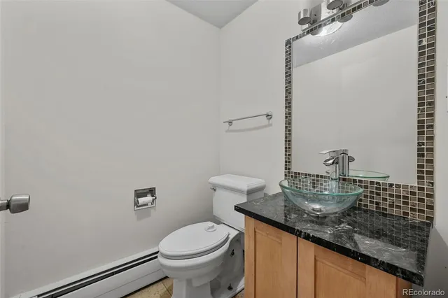 a bathroom with a granite countertop sink a mirror and shower