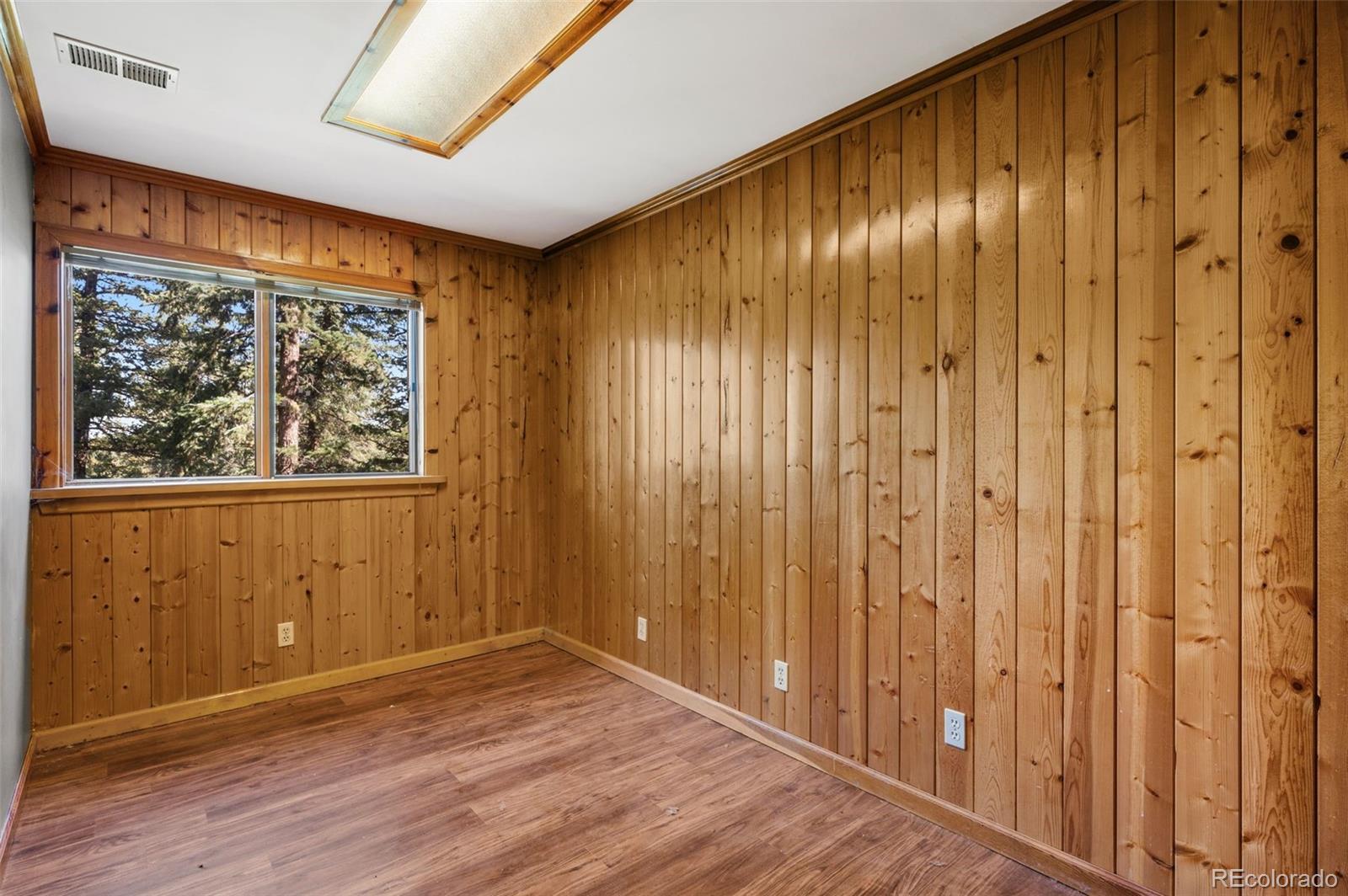 30243 Pine Crest Drive Evergreen, CO 80439 - Photo 24 of 36 a view of a hallway with wooden floor