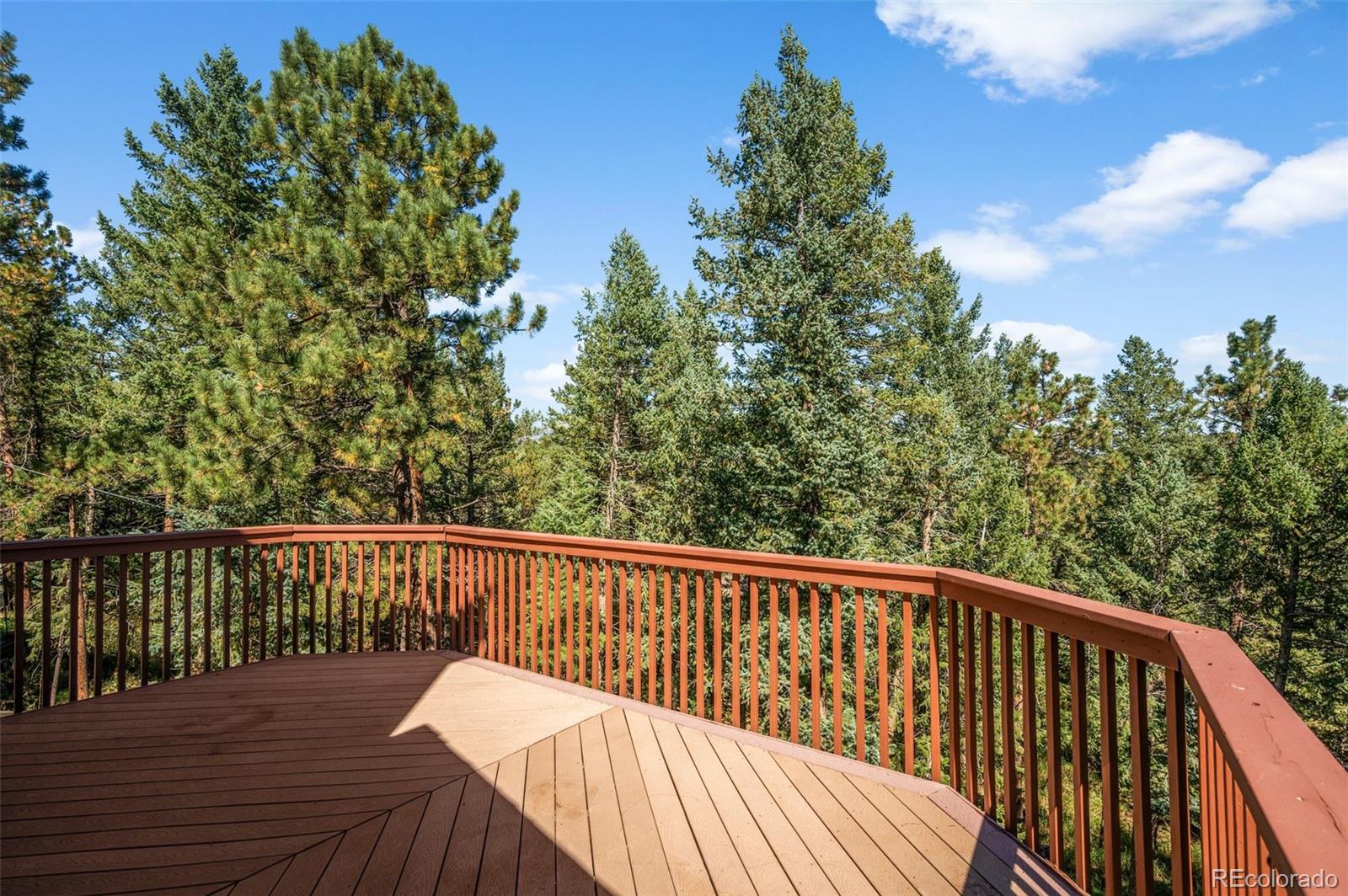 30243 Pine Crest Drive Evergreen, CO 80439 - Photo 29 of 36 a view of balcony with wooden floor and fence