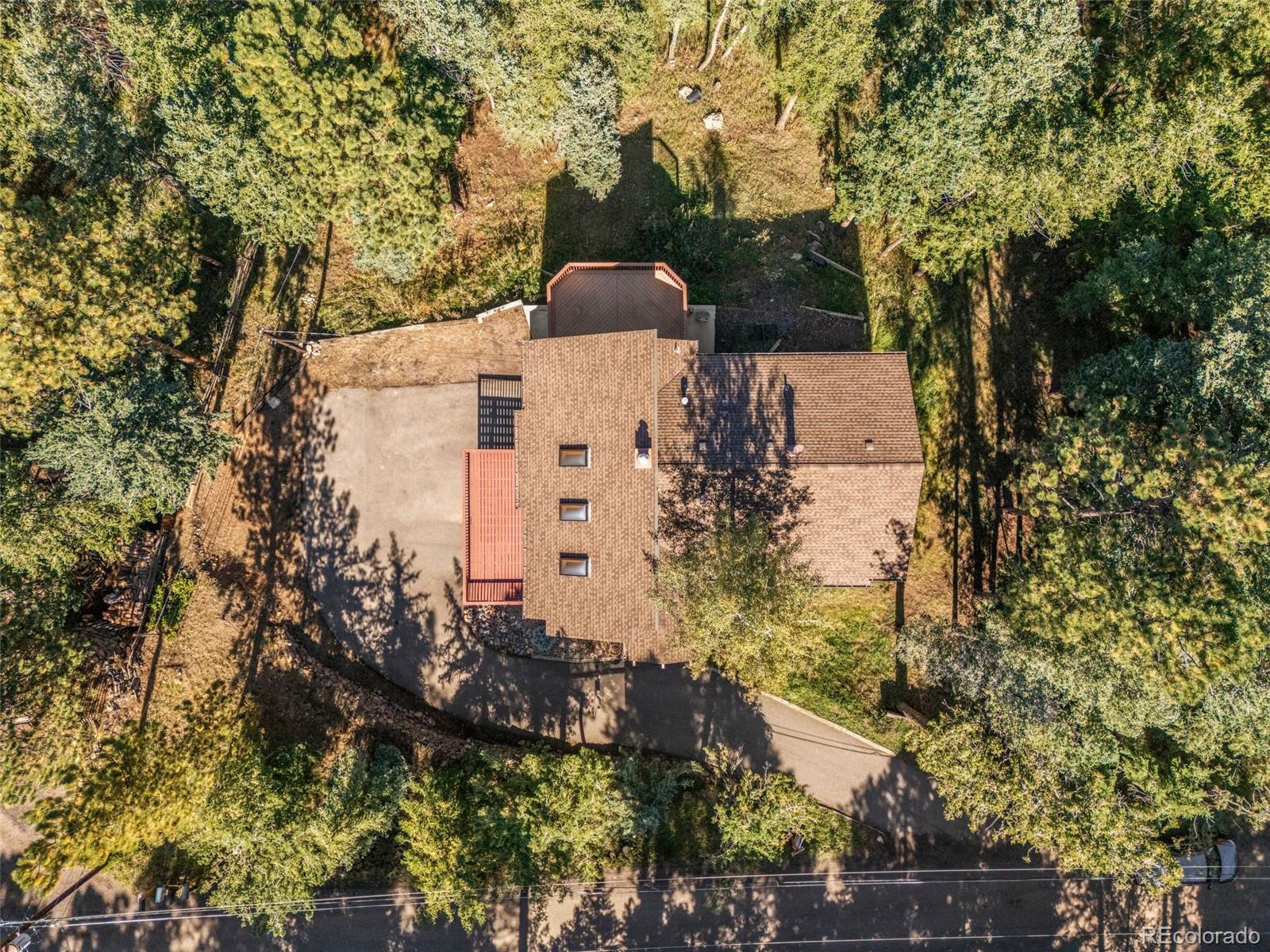 30243 Pine Crest Drive Evergreen, CO 80439 - Photo 3 of 36 an aerial view of a house with a yard and large tree