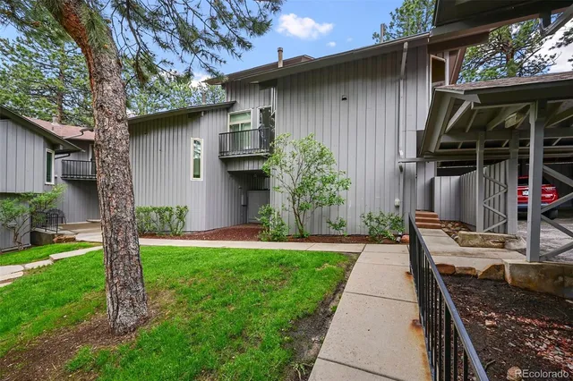 a front view of house with a garden