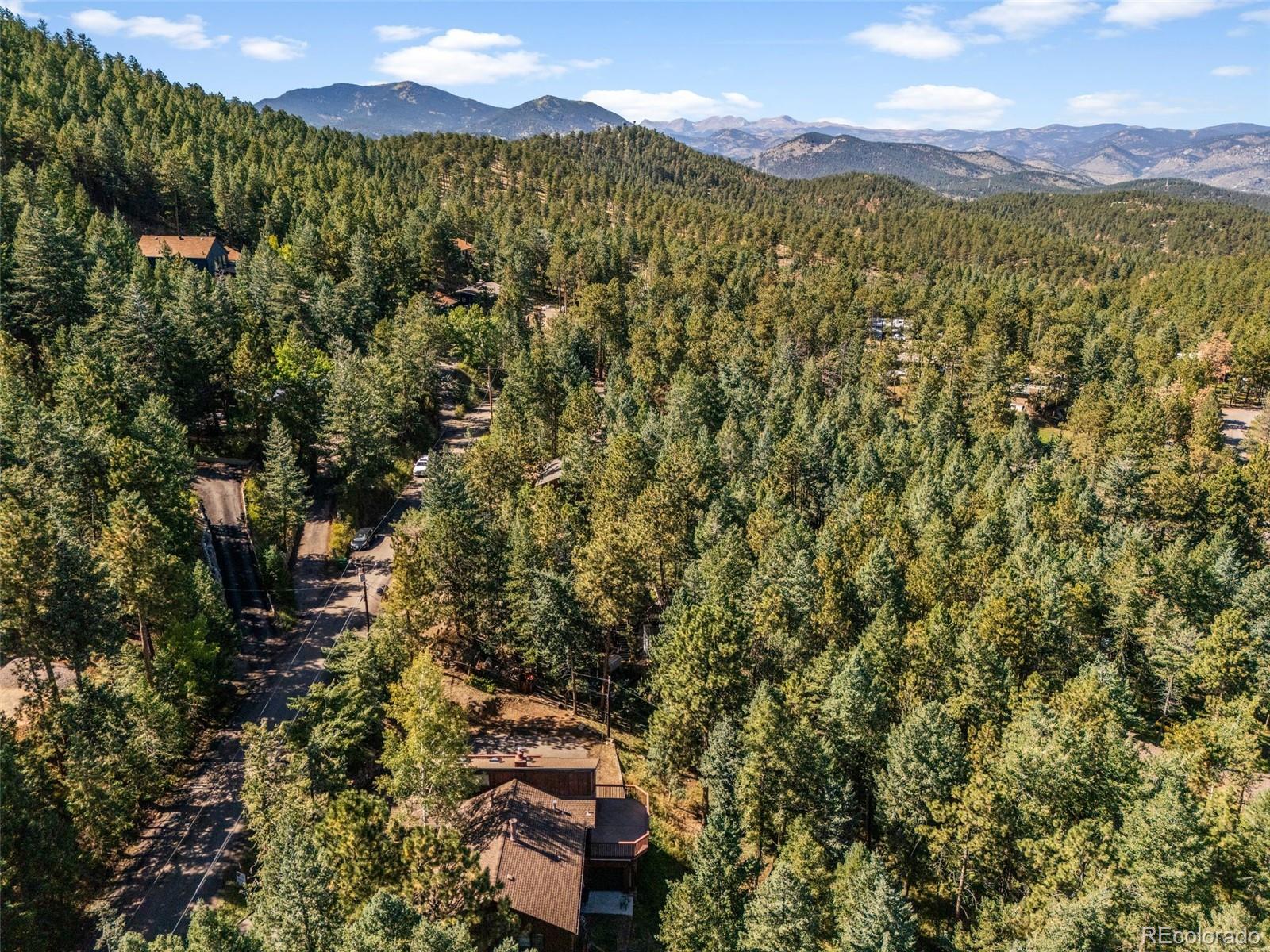30243 Pine Crest Drive Evergreen, CO 80439 - Photo 7 of 36 a view of a city with a mountain