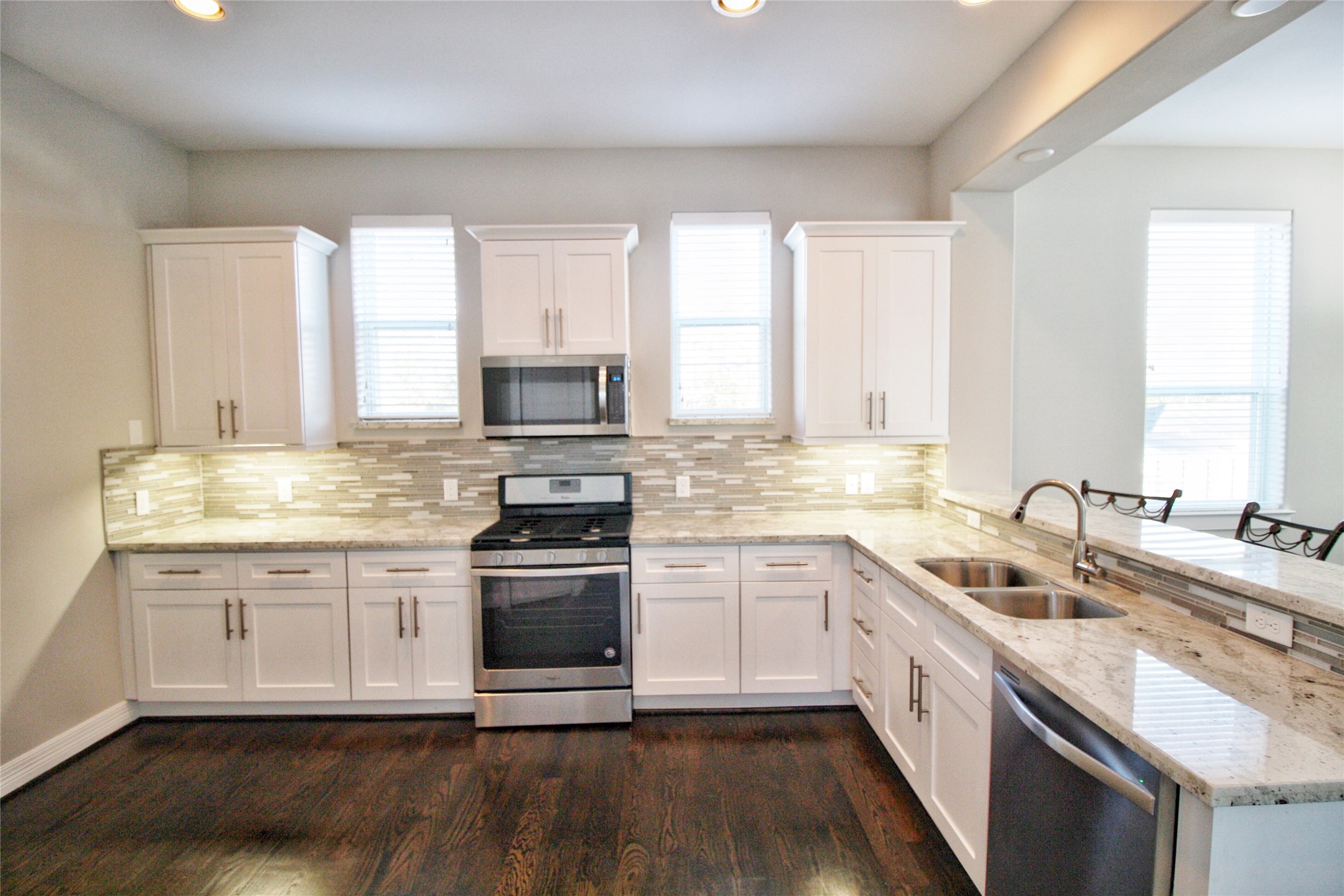 709 Link Road Houston, TX 77009 - Photo 9 of 46 a kitchen with a sink white cabinets and appliances