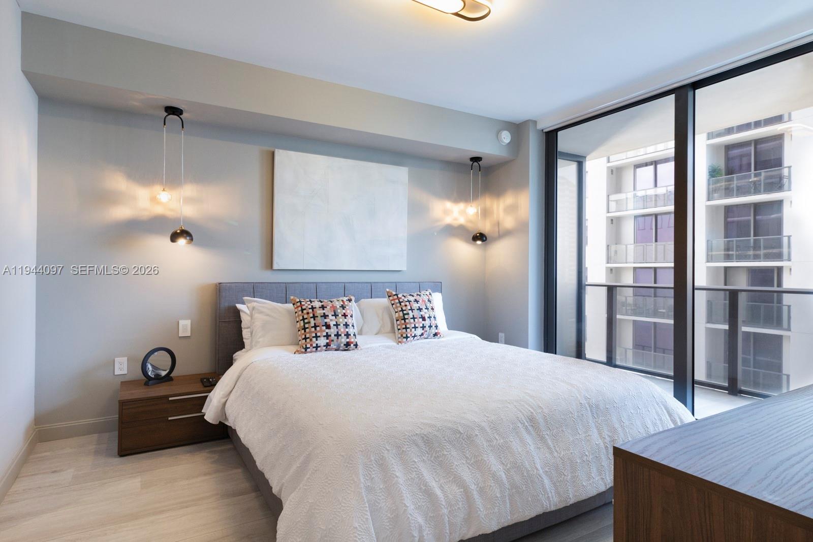 55 Southwest 9th Street, Unit 3010 Miami, FL 33130 - Photo 4 of 15 a bedroom with a bed and a window