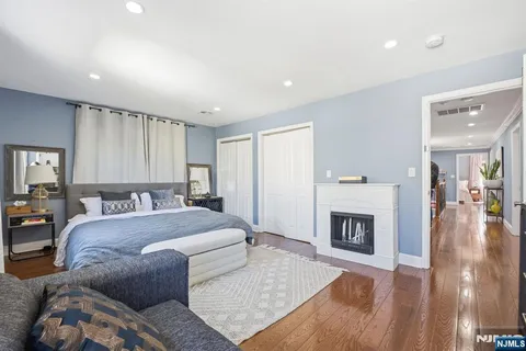 a spacious bedroom with a large bed a fireplace and a couch