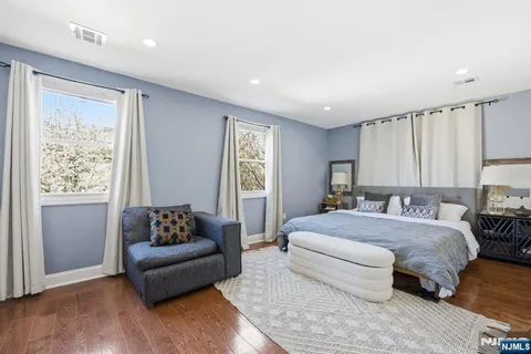 a spacious bedroom with a bed and a couch