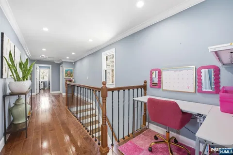 a view of a room with furniture wooden floor and windows