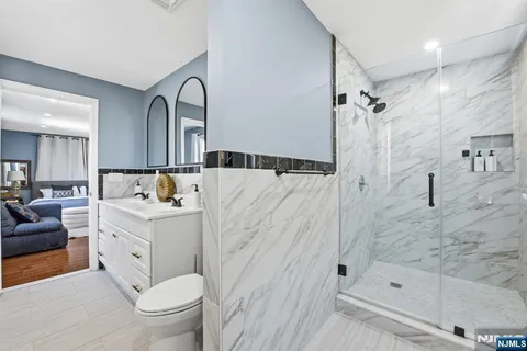 a bathroom with a sink a toilet and shower