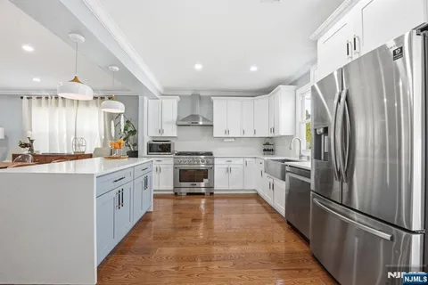 a large kitchen with cabinets stainless steel appliances and a counter top space