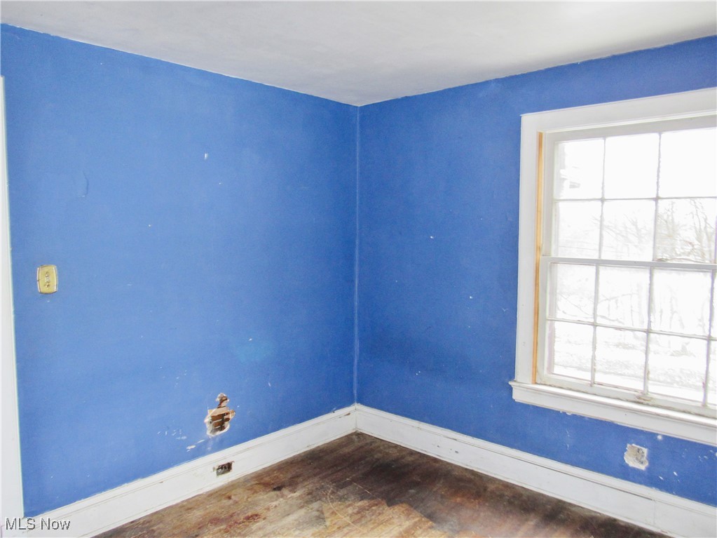 14450 Superior Road Cleveland, OH 44118 - Photo 17 of 35 Unfurnished room with plenty of natural light, baseboards, and dark wood-style floors