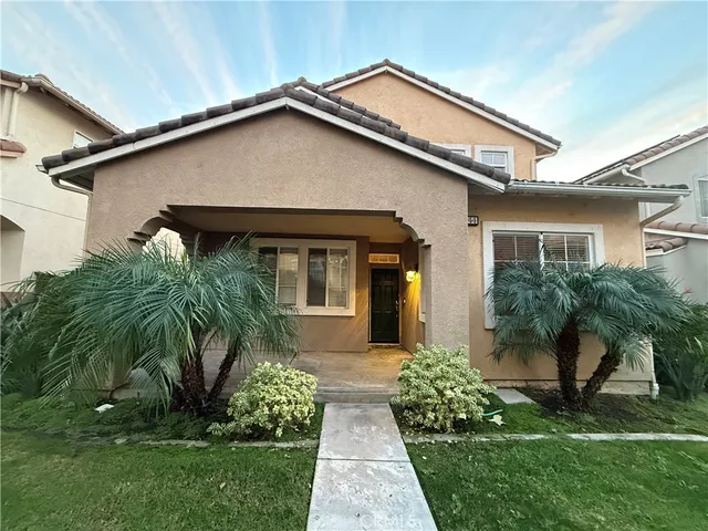 a front view of house with a garden