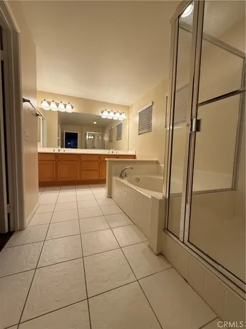 a large white kitchen with a sink and refrigerator