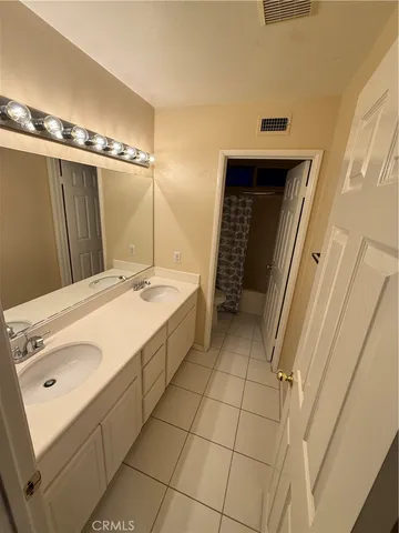 a bathroom with a sink a mirror and a shower