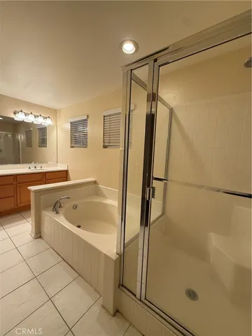 a bathroom with a tub a sink and a shower