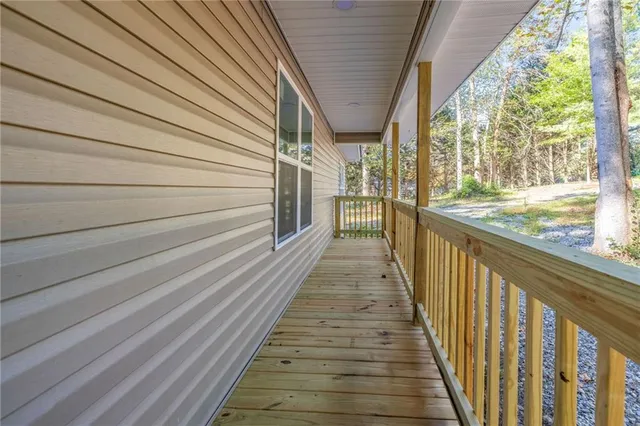 a view of a porch with wooden floor and stairs