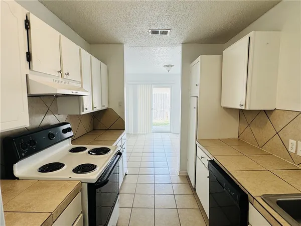 a kitchen with a stove and a sink