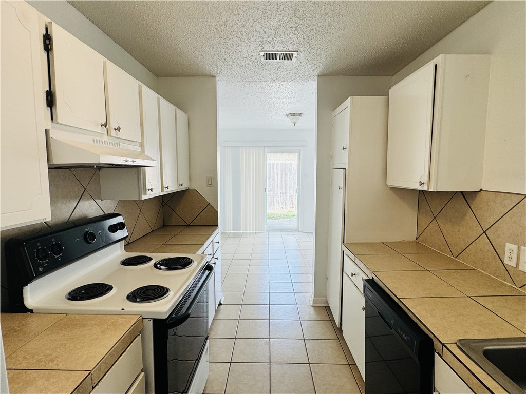 2119 Zephyr Ingleside, TX 78362 - Photo 6 of 9 a kitchen with a stove and a sink