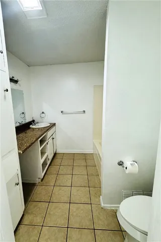 a kitchen with a stove top oven and sink