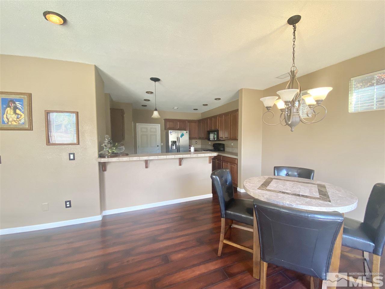 11034 Colton Drive Reno, NV 89521 - Photo 3 of 13 a view of a dining room with furniture window and wooden floor