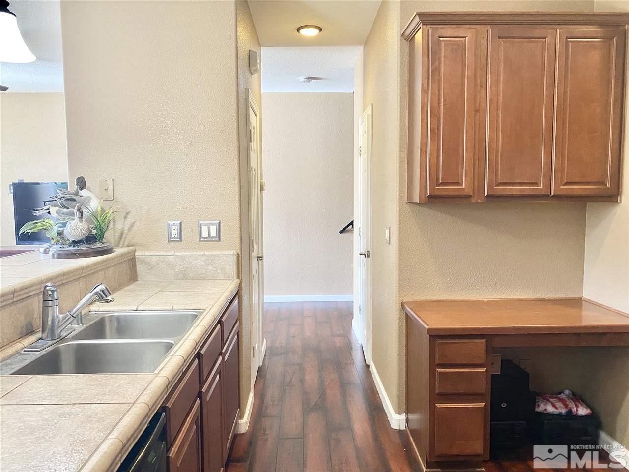 11034 Colton Drive Reno, NV 89521 - Photo 4 of 13 a kitchen with a sink and a refrigerator