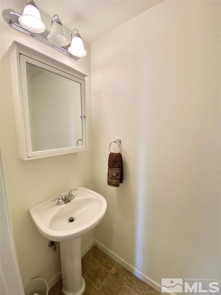 11034 Colton Drive Reno, NV 89521 - Photo 6 of 13 a bathroom with a toilet sink and mirror